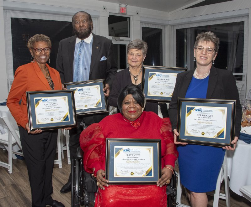 Volunteers are the backbone of the organization. The committee chairs were recognized for their contributions. Shown are (l-r) Sandy Baynard, Melvin Mitchell, Sharon Bernstein and Michele Warch. Seated is Robin Fisher. Not shown are Jacob Schiavo and Clara Licata.
